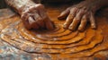 Closeup of a potters fingers gently scoring intricate patterns into the leatherhard clay creating a unique texture with