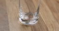 Closeup pour clean water into glass on wood table Royalty Free Stock Photo