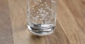 Closeup pour clean water into glass on wood table Royalty Free Stock Photo