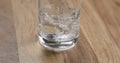 Closeup pour clean water into glass on wood table Royalty Free Stock Photo