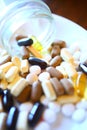 Closeup macro view of all sorts mixed organic vitamin supplements pills, tablets and capsules Royalty Free Stock Photo