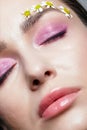 Closeup pov shot of human female face with pink eyes shadows. Eyes closed Royalty Free Stock Photo