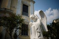 Closeup praying male angel statue at front of St. Laurence Church.