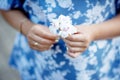 Closeup of prCloseup of wwoman holding flower in handslly. egnant woman holding flower and touching her belly