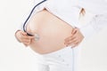 Closeup. pregnant woman listening to baby`s heartbeat using a stethoscope