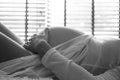 Closeup of pregnant woman lying in bed and touching her belly at home Royalty Free Stock Photo