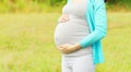 Closeup pregnant young woman outdoors