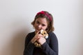 Closeup of pretty eight-year old little girl hugging plush toy Royalty Free Stock Photo