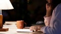 Closeup of pretty girl reading book in cozy cafe over road forgetting about time Royalty Free Stock Photo