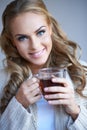 Closeup of a pretty woman holding a cup of tea Royalty Free Stock Photo