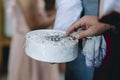 Closeup of priest in armenian church puts cross on the rings and blessing just married couples Royalty Free Stock Photo