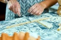 Closeup process making homemade pasta. Chef cook cutting with knife fresh dough for italian traditional pasta to thin ribbon. Royalty Free Stock Photo