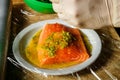 closeup process of marinating raw salmon fillet