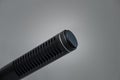 Closeup of a professional black metal microphone for recording on gray background Royalty Free Stock Photo