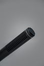 Closeup of a professional black metal microphone for recording on gray background Royalty Free Stock Photo