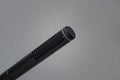 Closeup of a professional black metal microphone for recording on gray background Royalty Free Stock Photo