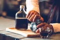 Closeup of professional female barista hand opening bottle of coffee to making cup of coffee. Happy young woman at counter bar in Royalty Free Stock Photo