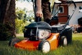 Professional gardener turning on the lawn mower