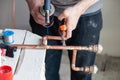 Closeup professional master plumber hands soldering copper pipes gas burner. Concept installation, plumbing replacement, solder Royalty Free Stock Photo