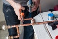 Closeup professional master plumber hands soldering copper pipes gas burner. Concept installation, plumbing replacement, solder Royalty Free Stock Photo