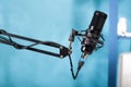 Closeup of professional microphone swivel boom arm stand in empty vlog broadcasting studio Royalty Free Stock Photo