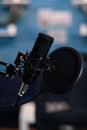 Closeup of professional podcast microphone standing on desk table