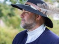 Closeup profile of handsome man dressed as character from the 17th Century French regime