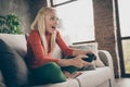 Closeup profile photo of pretty funny lady hold gamepad console joystick addicted gamer excited open mouth sitting comfy