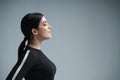 Closeup profile portrait of confident woman with closed eyes