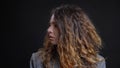 Closeup profile shoot of young pretty caucasian female with brunette curly hair looking forward with background isolated Royalty Free Stock Photo