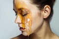 Closeup profile side view portrait of beautiful young brunette woman with freckles and honey on face with closed eyes and serious Royalty Free Stock Photo