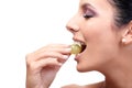 Closeup profile of young woman eating grapes Royalty Free Stock Photo