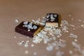 Closeup protein bar in the cut sprinkled with rice flakes on the baking paper, Teflon paper, Diet snacks, sports nutrition. Whey p Royalty Free Stock Photo