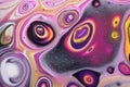 Closeup on a psychedelic abstract acrylic pour painting done in four colors. Royalty Free Stock Photo