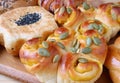 Closeup pumpkin roll with assorted seeds and grains healthy breads in background