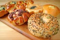 Closeup pumpkin seeds and sesame bread with assorted sweet and savory breads in background