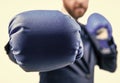 closeup punch of cropped businessman in boxing gloves ready for corporate business battle, knockout. Royalty Free Stock Photo