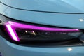 Closeup of a purple led light of a car's headlight Royalty Free Stock Photo