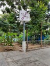 Closeup of Purple Line Namma Metro metro rail sign and symbol pole in front of the Yelachenahalli, Metro Station, Kanakapura Road