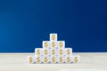 Closeup of a pyramid of white cubes with Dollar sign on them