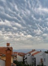 Closeup of a quaint town under the Mammatus clouds