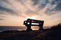 Closeup of a quiet bench on a sandy beach at sunset in Porthcawl