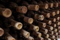 Closeup of a rack with old wine bottles covered in dust and cobweb in a winecellar in France Royalty Free Stock Photo