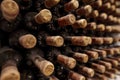 Closeup of a rack with old wine bottles covered in dust and cobweb in a winecellar in France Royalty Free Stock Photo