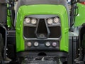 Closeup of a radiator grill, headlights of a modern tractor Royalty Free Stock Photo