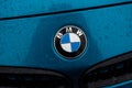 Closeup of rain drops on bmw logo on blue car front Royalty Free Stock Photo