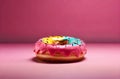 Closeup Rainbow Donut isolated. Break time with Doughnut side view on pink background