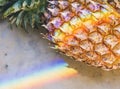 Closeup of rainbow lights on pineapple