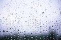 Closeup raindrops on glass and blurry background Royalty Free Stock Photo