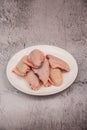 raw chicken wings on gray cement background